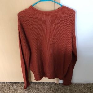 Knitted orange sweater.